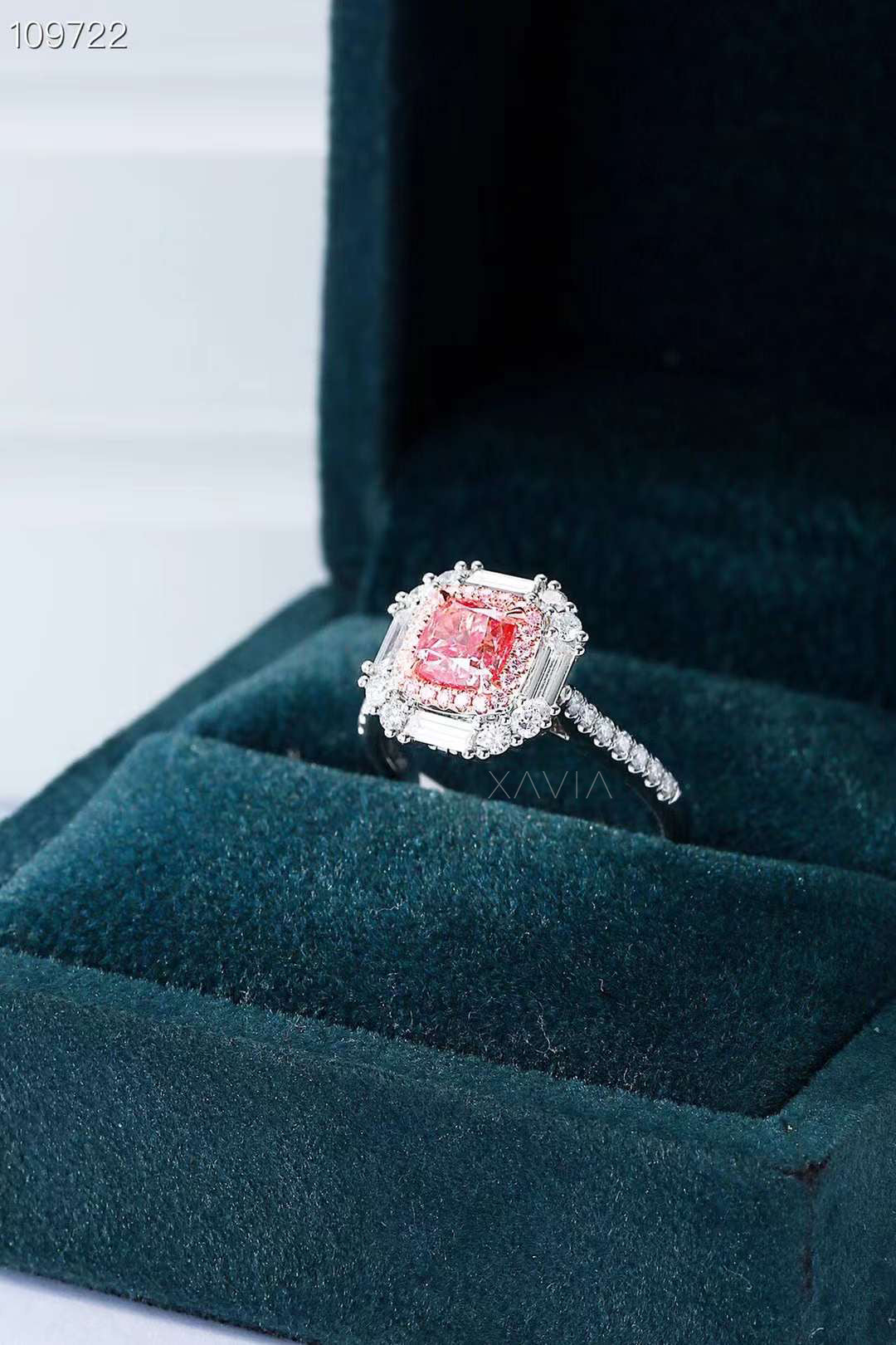 halo diamond ring with pink center shown in luxury ring box
